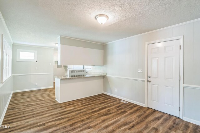 605 Sexton Ave, Zebulon, NC 27597 - empty room with crown molding, dark wood finished floors, a textured ceiling, and baseboards