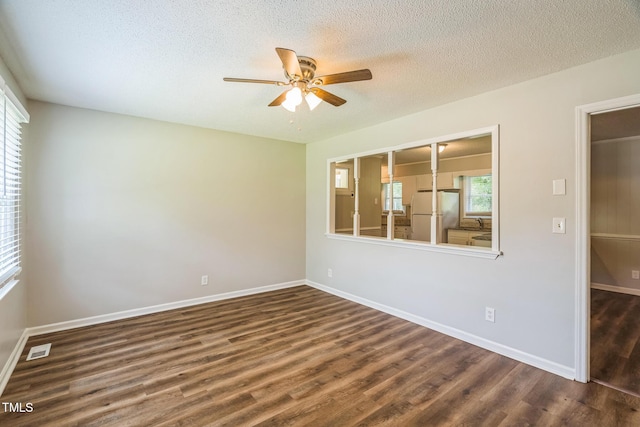 605 Sexton Ave, Zebulon, NC 27597 - spare room with a ceiling fan, dark wood-type flooring, a textured ceiling, baseboards, and a sink