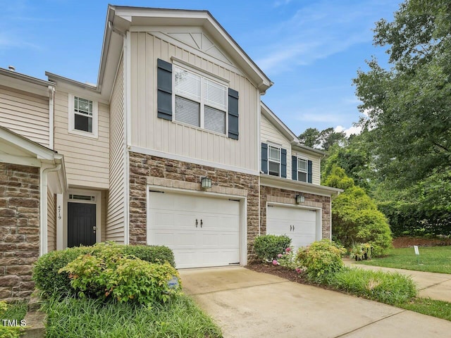 4719 Altha St, Raleigh, NC 27606 - townhome / multi-family property featuring stone siding, a garage, driveway, and board and batten siding