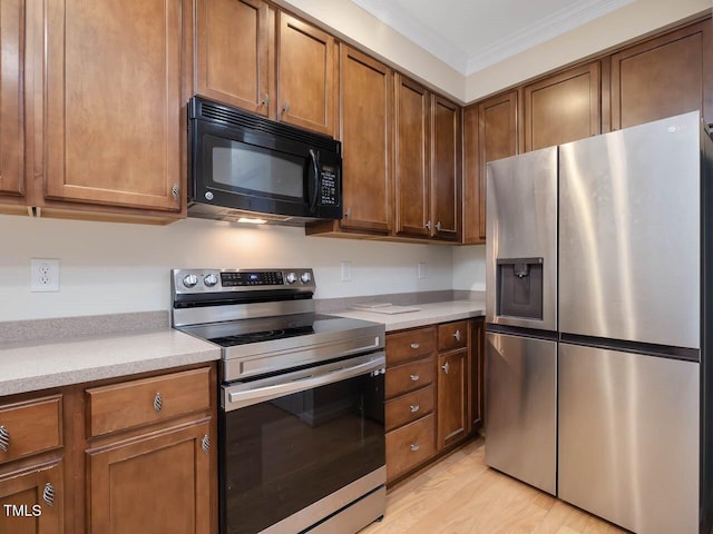 4719 Altha St, Raleigh, NC 27606 - kitchen with stainless steel appliances, ornamental molding, light wood-style floors, light countertops, and brown cabinets