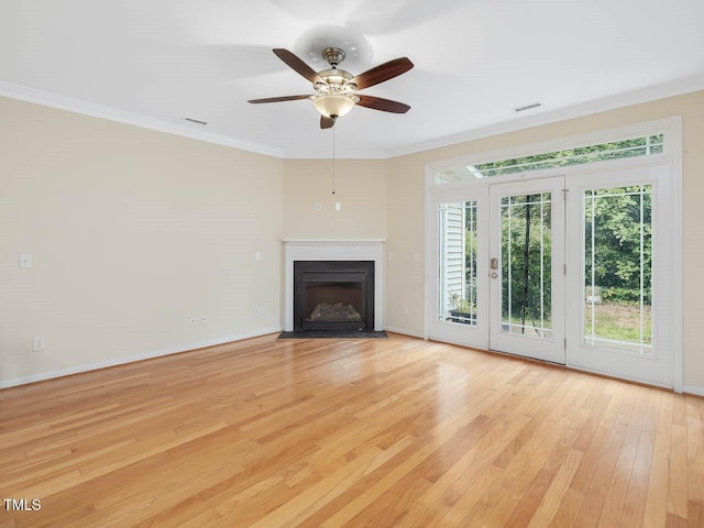 4719 Altha St, Raleigh, NC 27606 - unfurnished living room with light wood-style flooring, crown molding, baseboards, a ceiling fan, and a fireplace with flush hearth