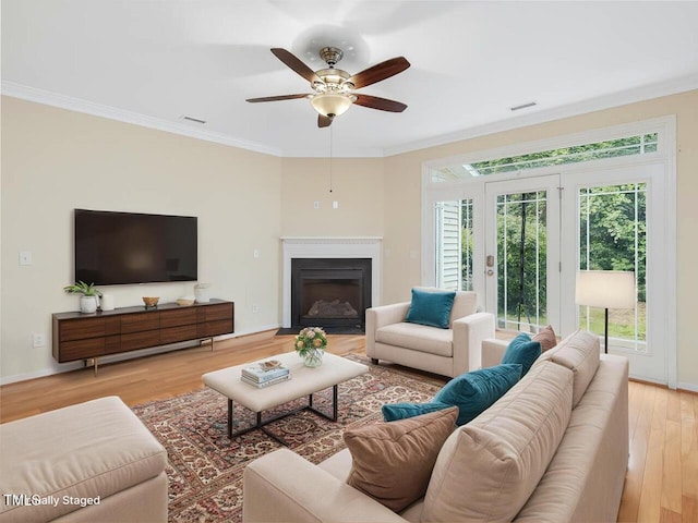 4719 Altha St, Raleigh, NC 27606 - living room with ornamental molding, wood finished floors, ceiling fan, and a fireplace with flush hearth