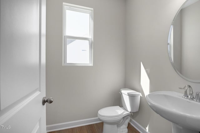 267 Old Fashioned Way, Lillington, NC 27546 - bathroom with baseboards, wood finished floors, toilet, and a sink