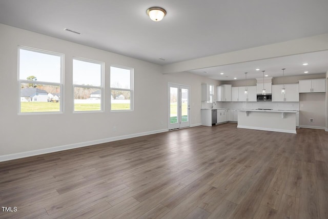 267 Old Fashioned Way, Lillington, NC 27546 - unfurnished living room with baseboards, dark wood-style flooring, recessed lighting, and a sink