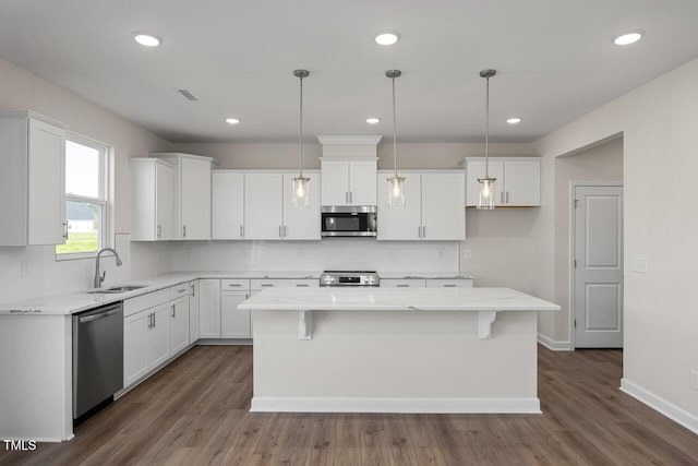 267 Old Fashioned Way, Lillington, NC 27546 - kitchen with stainless steel appliances, white cabinets, a center island, a sink, and dark wood-style floors