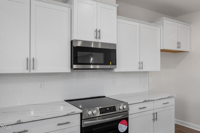 267 Old Fashioned Way, Lillington, NC 27546 - kitchen with appliances with stainless steel finishes, white cabinetry, light stone counters, decorative backsplash, and dark wood-style flooring