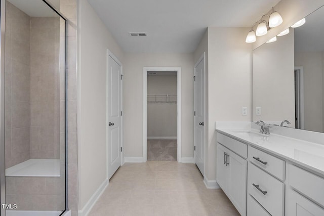 267 Old Fashioned Way, Lillington, NC 27546 - full bath featuring vanity, a stall shower, baseboards, tile patterned flooring, and a walk in closet