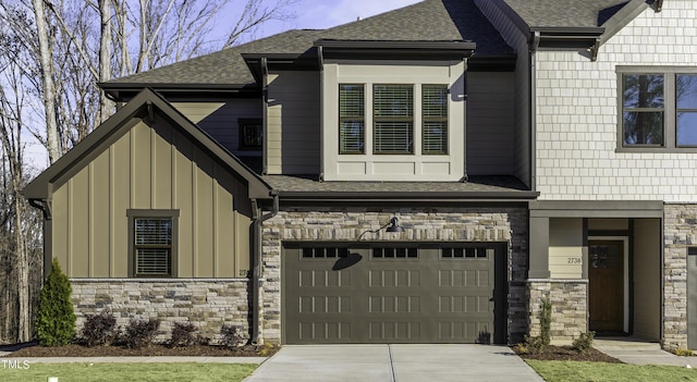 974 Double Helix Rd, Apex, NC 27523 - view of front of house with stone siding, board and batten siding, a garage, and a shingled roof