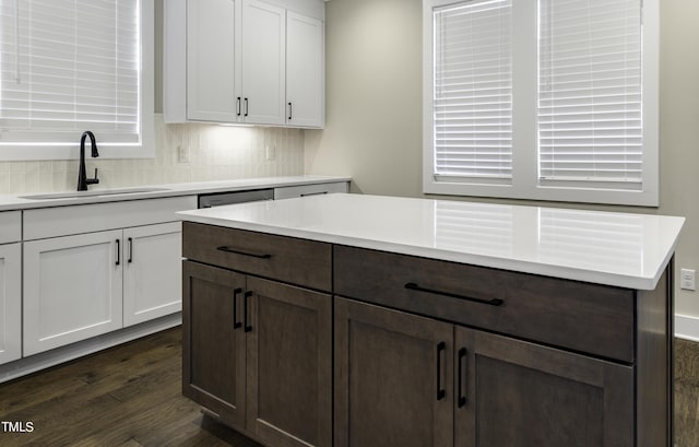 974 Double Helix Rd, Apex, NC 27523 - kitchen featuring a sink, light countertops, backsplash, dark wood finished floors, and dark brown cabinetry