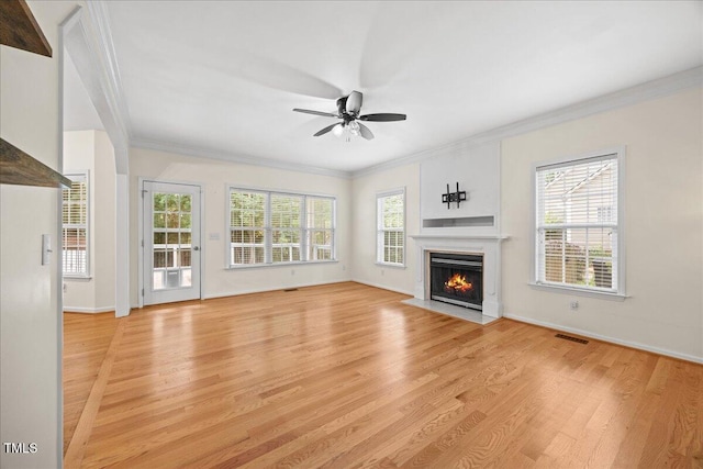 618 Durwood Dr, Raleigh, NC 27603 - unfurnished living room with light wood-style floors, a ceiling fan, crown molding, and healthy amount of natural light