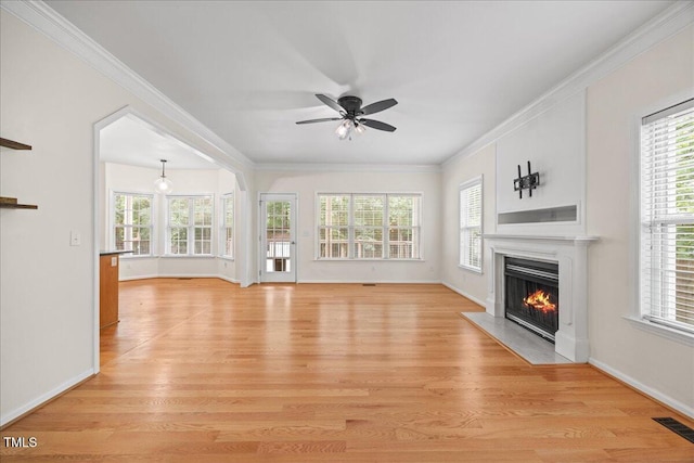618 Durwood Dr, Raleigh, NC 27603 - unfurnished living room with a fireplace with flush hearth, plenty of natural light, crown molding, and light wood-style floors