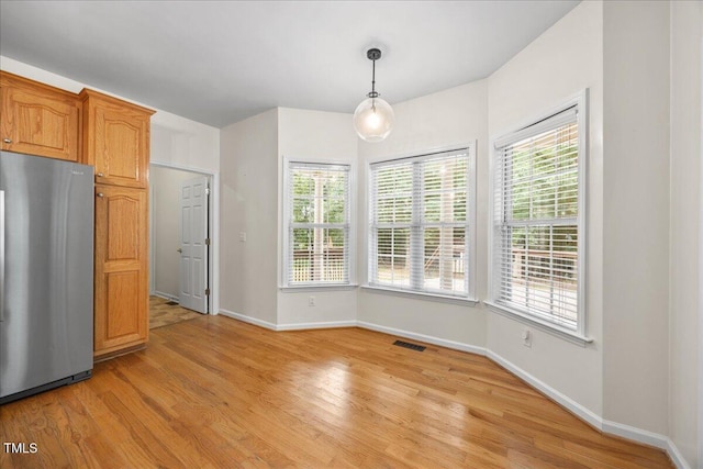 618 Durwood Dr, Raleigh, NC 27603 - unfurnished dining area with light wood-type flooring and baseboards