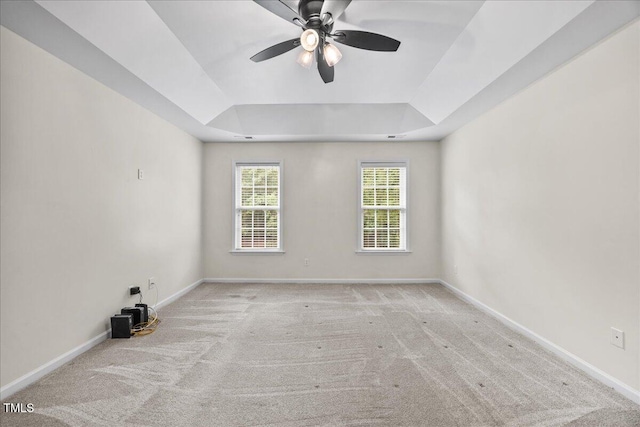 618 Durwood Dr, Raleigh, NC 27603 - spare room featuring a tray ceiling, carpet, baseboards, and ceiling fan