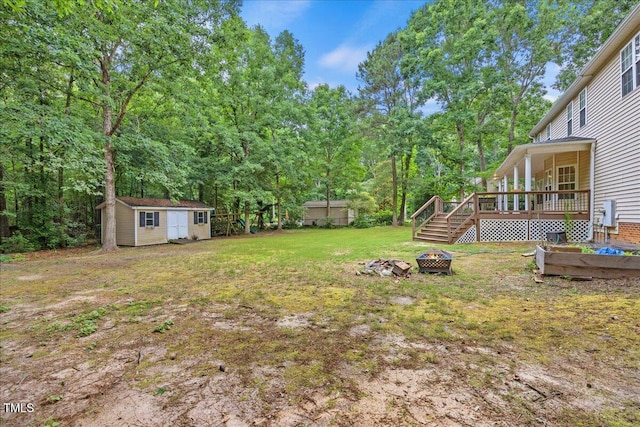 618 Durwood Dr, Raleigh, NC 27603 - view of grassy yard with a fire pit and a deck