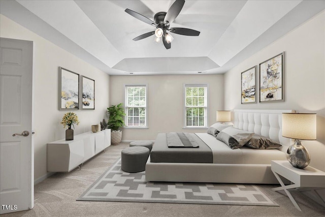618 Durwood Dr, Raleigh, NC 27603 - bedroom featuring a tray ceiling, light carpet, baseboards, and ceiling fan