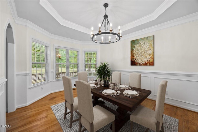 618 Durwood Dr, Raleigh, NC 27603 - dining area with a chandelier, plenty of natural light, light wood finished floors, crown molding, and a tray ceiling