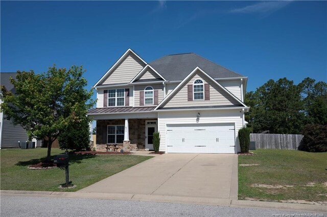 579 Wedgefield Dr, Raeford, NC 28376 - view of front of property featuring covered porch, concrete driveway, stone siding, and an attached garage