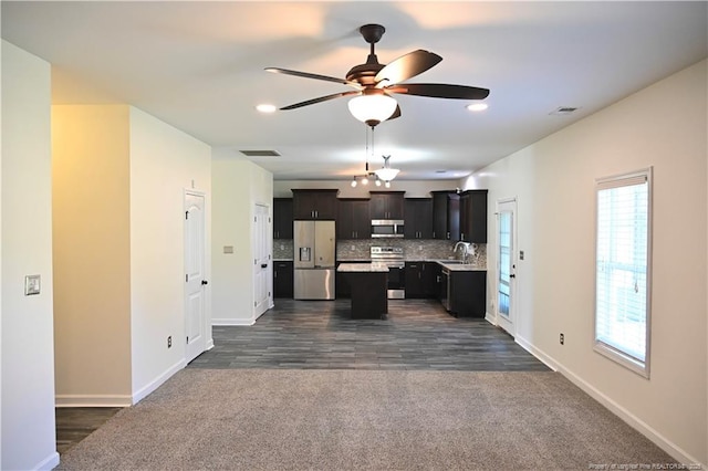 579 Wedgefield Dr, Raeford, NC 28376 - kitchen featuring stainless steel appliances, a sink, light countertops, a kitchen island, and dark carpet