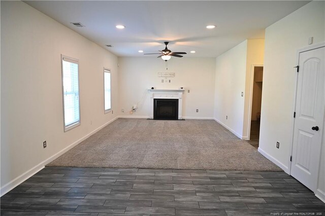 579 Wedgefield Dr, Raeford, NC 28376 - unfurnished living room with a fireplace with flush hearth, a ceiling fan, dark wood-style flooring, recessed lighting, and baseboards