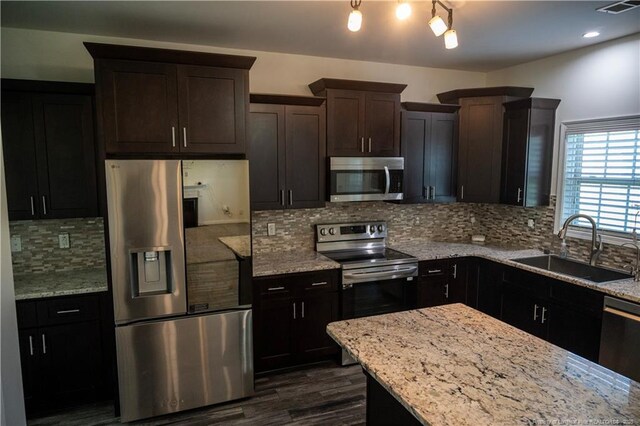 579 Wedgefield Dr, Raeford, NC 28376 - kitchen featuring appliances with stainless steel finishes, a sink, light stone countertops, dark wood-style floors, and backsplash
