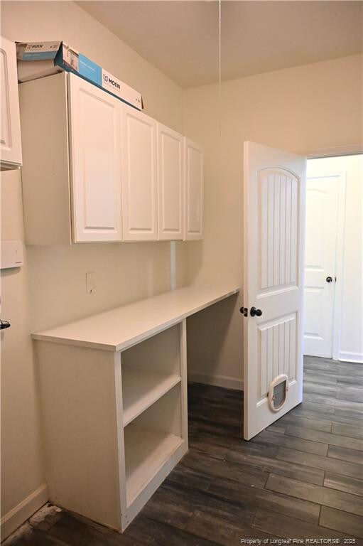 579 Wedgefield Dr, Raeford, NC 28376 - kitchen with white cabinets, baseboards, dark wood-style flooring, and light countertops