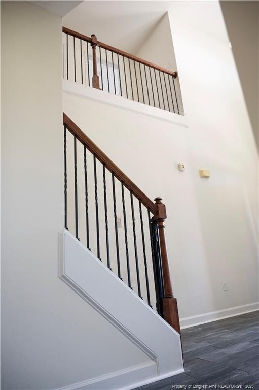 579 Wedgefield Dr, Raeford, NC 28376 - stairs with wood finished floors, baseboards, and a towering ceiling