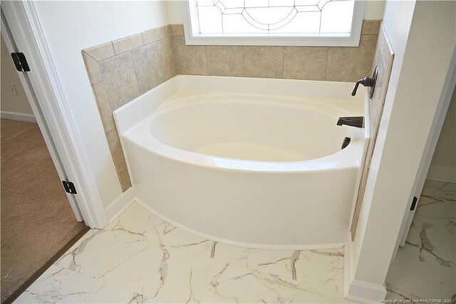 579 Wedgefield Dr, Raeford, NC 28376 - bathroom featuring marble finish floors, a bath, and baseboards