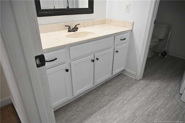 579 Wedgefield Dr, Raeford, NC 28376 - bathroom featuring vanity, toilet, and baseboards
