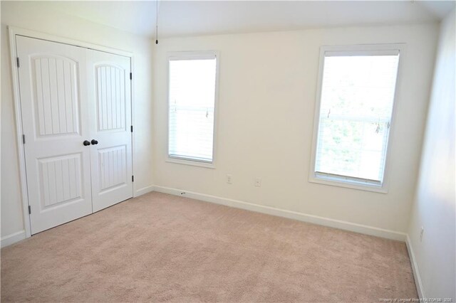579 Wedgefield Dr, Raeford, NC 28376 - unfurnished bedroom featuring light colored carpet, baseboards, and multiple windows