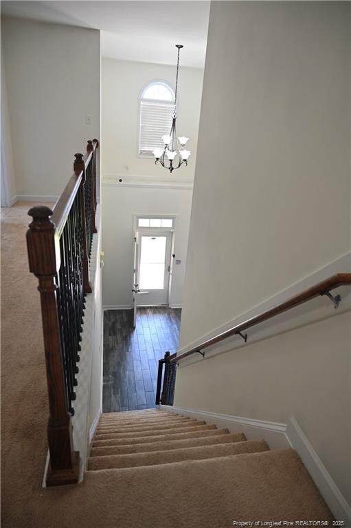 579 Wedgefield Dr, Raeford, NC 28376 - stairs with baseboards, a chandelier, and a towering ceiling