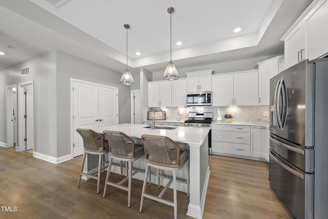 1727 Pinecliff Ct, Fuquay Varina, NC 27526 - kitchen with appliances with stainless steel finishes, backsplash, light countertops, white cabinets, and recessed lighting