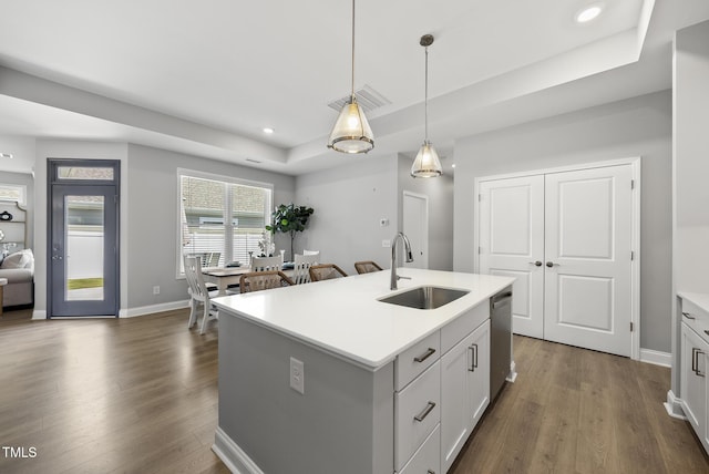 1727 Pinecliff Ct, Fuquay Varina, NC 27526 - kitchen with dark wood finished floors, dishwasher, light countertops, pendant lighting, and a kitchen island with sink
