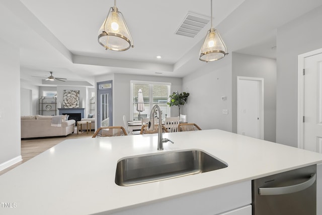1727 Pinecliff Ct, Fuquay Varina, NC 27526 - kitchen with dishwasher, a fireplace, light countertops, decorative light fixtures, and ceiling fan