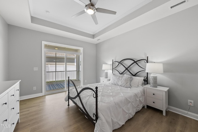 1727 Pinecliff Ct, Fuquay Varina, NC 27526 - bedroom with a raised ceiling, access to exterior, wood finished floors, and ceiling fan