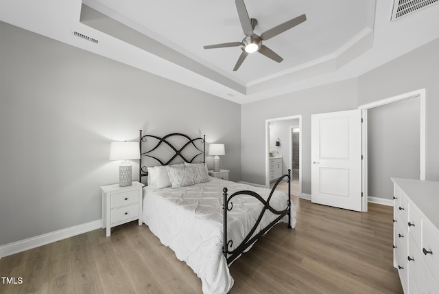 1727 Pinecliff Ct, Fuquay Varina, NC 27526 - bedroom with a tray ceiling, wood finished floors, ornamental molding, and ensuite bathroom