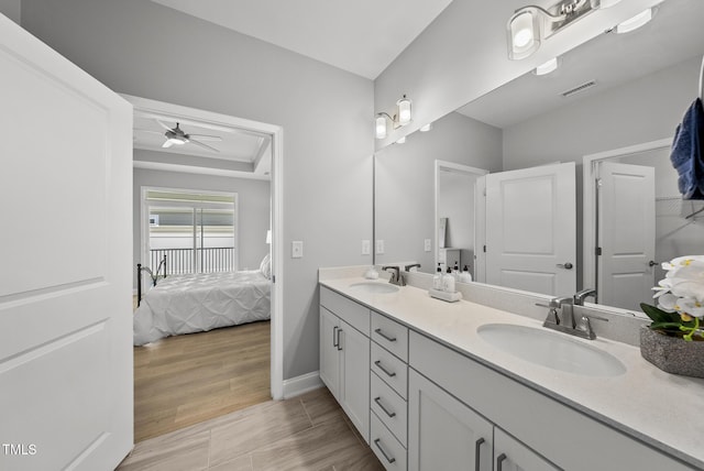 1727 Pinecliff Ct, Fuquay Varina, NC 27526 - bathroom featuring double vanity, ensuite bath, a ceiling fan, and wood finished floors