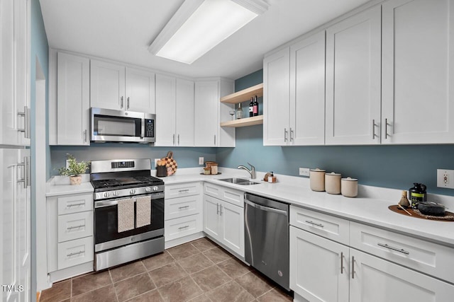 1826 Northgate St, Durham, NC 27704 - kitchen featuring stainless steel appliances, open shelves, a sink, white cabinetry, and light countertops