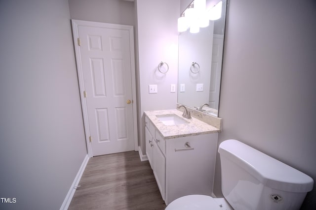8021 Wesley Farm Dr, Raleigh, NC 27616 - bathroom featuring vanity, wood finished floors, toilet, and baseboards