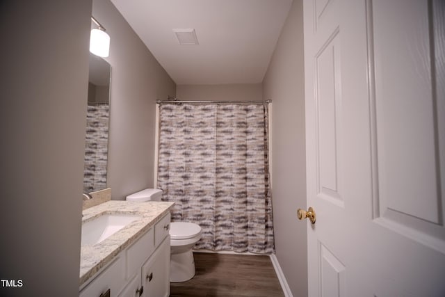 8021 Wesley Farm Dr, Raleigh, NC 27616 - full bath featuring vanity, toilet, wood finished floors, curtained shower, and baseboards