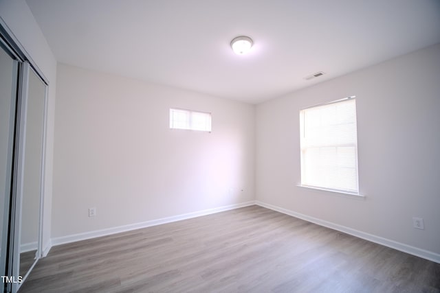 8021 Wesley Farm Dr, Raleigh, NC 27616 - unfurnished bedroom featuring wood finished floors, a closet, and baseboards