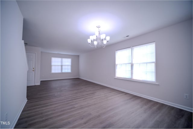8021 Wesley Farm Dr, Raleigh, NC 27616 - spare room featuring a chandelier, baseboards, and dark wood finished floors
