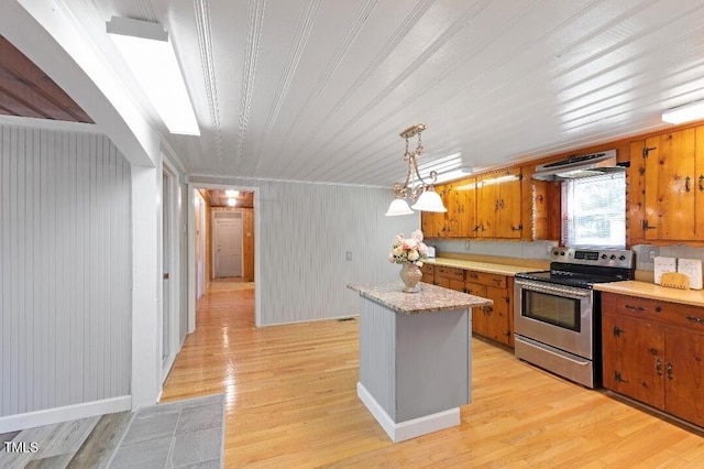 803 Hare St, Selma, NC 27576 - kitchen featuring electric stove, exhaust hood, brown cabinets, light countertops, and a kitchen island