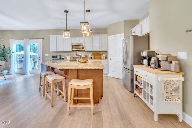 2310 Turning Pointe Way, Hillsborough, NC 27278 - kitchen featuring appliances with stainless steel finishes, light wood-style floors, and white cabinetry