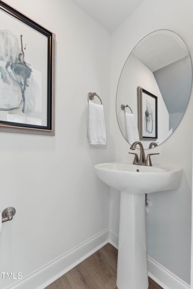144 N White St # 100, Wake Forest, NC 27587 - bathroom with baseboards, wood finished floors, and a sink