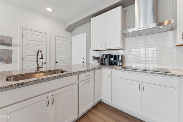 144 N White St # 100, Wake Forest, NC 27587 - kitchen with wall chimney exhaust hood, a sink, black electric stovetop, white cabinetry, and decorative backsplash