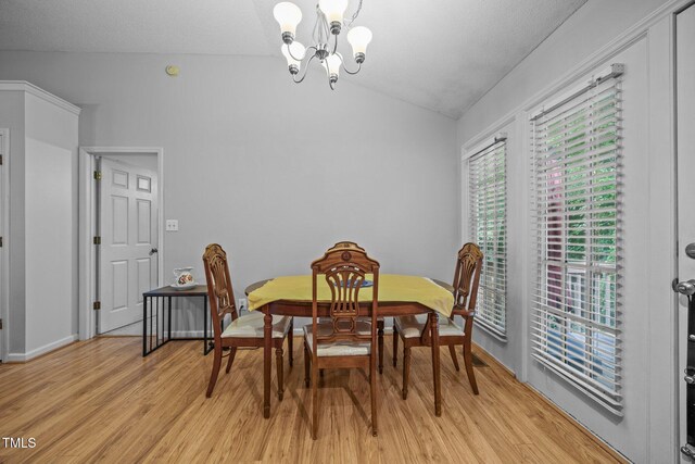 5405 Swordsman Ct, Knightdale, NC 27545 - dining room featuring a chandelier, vaulted ceiling, light wood-type flooring, and baseboards