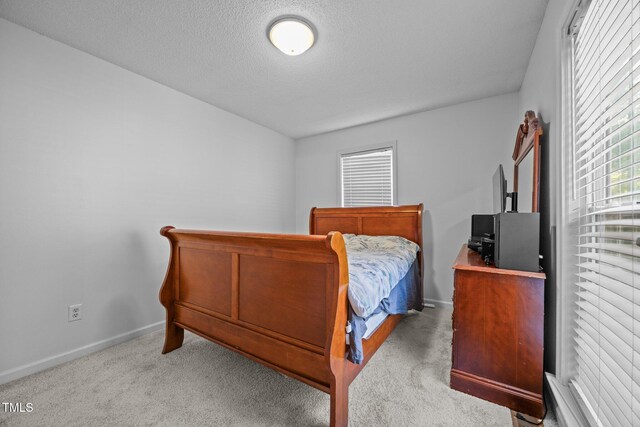 5405 Swordsman Ct, Knightdale, NC 27545 - carpeted bedroom with baseboards and a textured ceiling