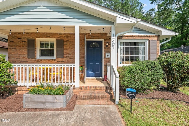 1207 Grant St, Durham, NC 27701 - property entrance featuring brick siding and covered porch