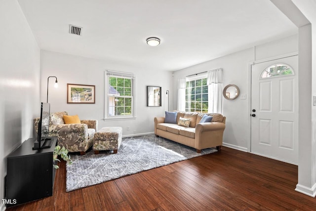 1207 Grant St, Durham, NC 27701 - living area with wood-type flooring, healthy amount of natural light, and baseboards