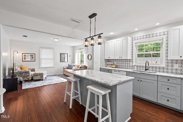 1207 Grant St, Durham, NC 27701 - kitchen with a sink, open floor plan, a kitchen island, backsplash, and recessed lighting
